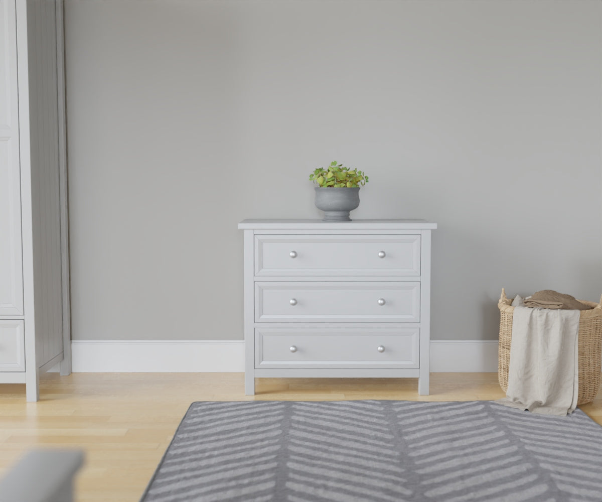 Maine 3 Drawer Chest in grey has 3 wide drawers. This lifestyle image features other products from the Julian Bowen Maine range.