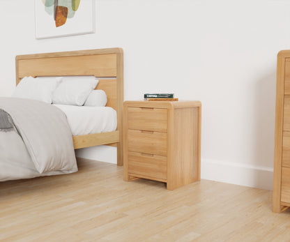 Julian Bowen Curve 3 Drawer Beside. Angled front view lifestyle image, with the product next to the Curve Bed Frame.