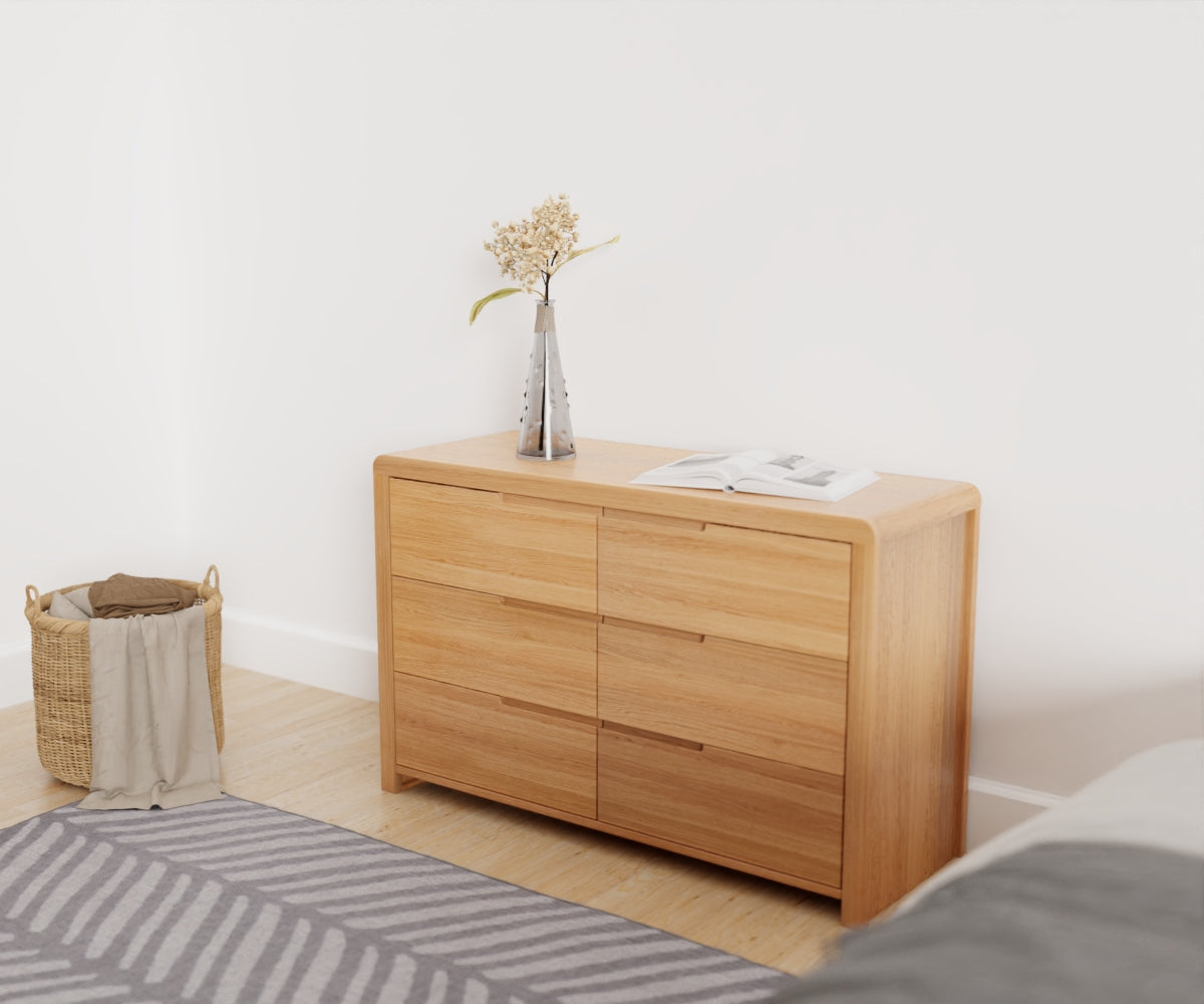 Julian Bowen Curve 6 Drawer Chest. Angled front view lifestyle image.