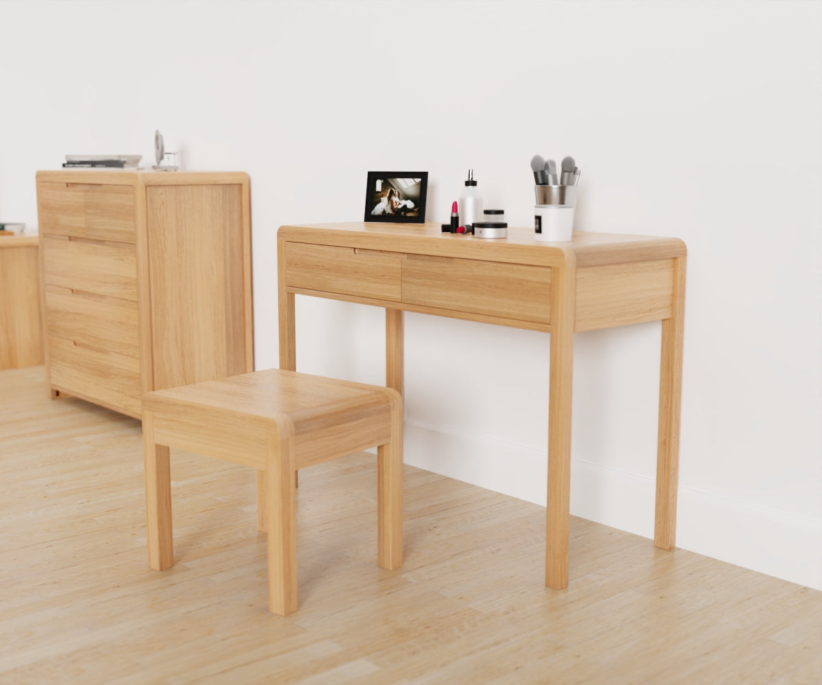 Julian Bowen Curve Dressing Table & Stool. Angled front view with other products from the range visible in the background.