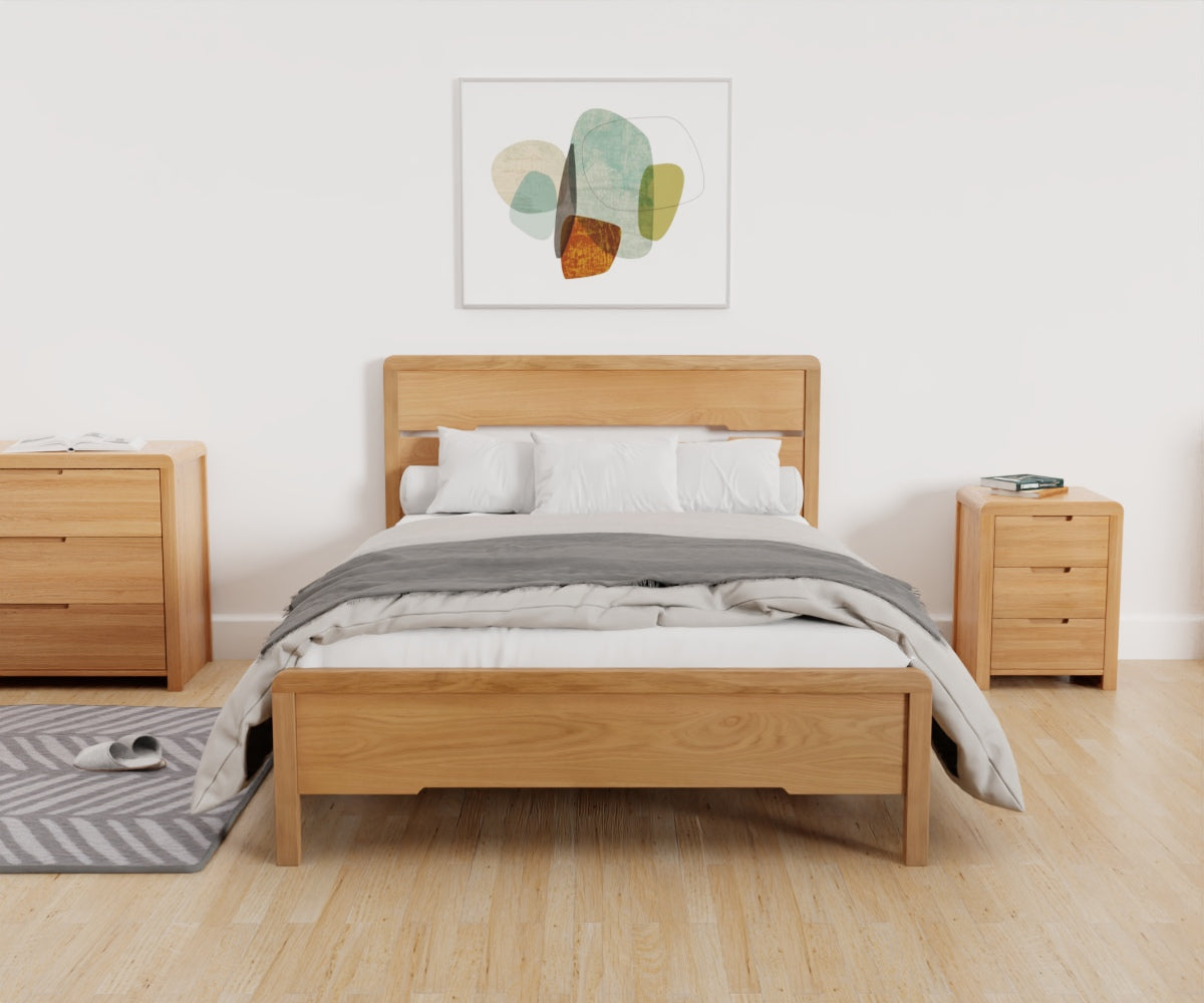 Curve Bed Frame lifestyle image taken from the footend, featuring the bed made up alongside other products from the Julian Bowen Curve range.