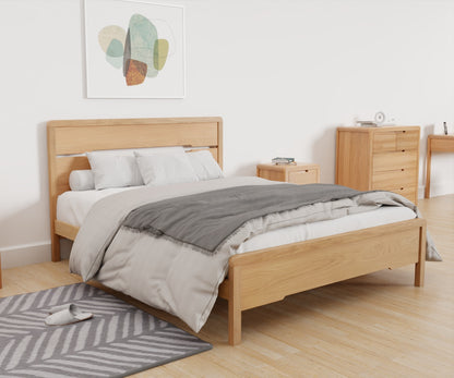 Curve Bed Frame lifestyle image, featuring the bed made up alongside other products from the Julian Bowen Curve range.