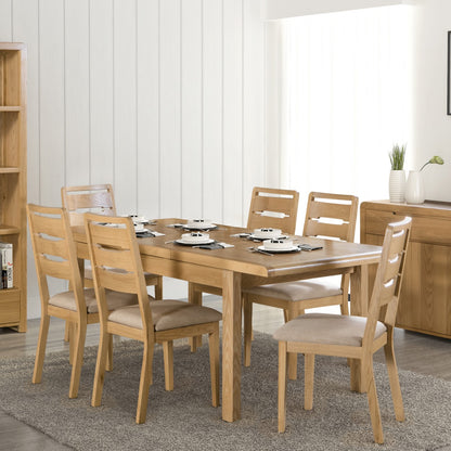 Julian Bowen Curve Oak Dining Table. Lifestyle image with other products from the range, including 6 Curve Dining Chairs.