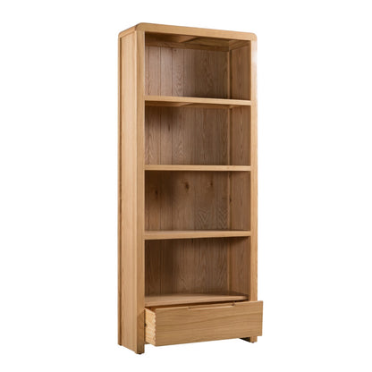 Julian Bowen Curve Tall Bookcase. Angled front view cut-out image on a white background, with drawer open.