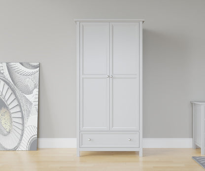 Maine 2 Door Wardrobe in Grey has 2 tall doors and 1 drawer at the bottom. This lifestyle image features other products from the Julian Bowen Maine range.