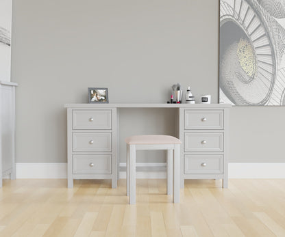 Maine Dressing Table in grey has a square-edged top, with 3 vertical drawer at both ends. This lifestyle image features other products from the Julian Bowen Maine range.