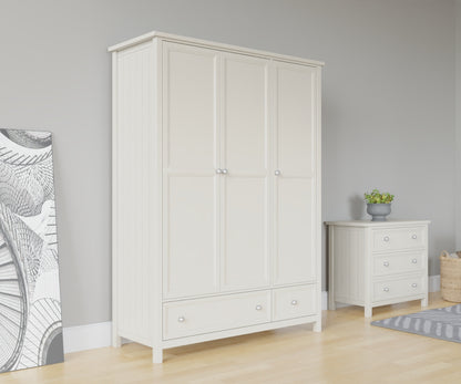 Maine 3 Door Wardrobe in white has 3 tall doors and 2 drawers at the bottom. This lifestyle image features other products from the Julian Bowen Maine range.