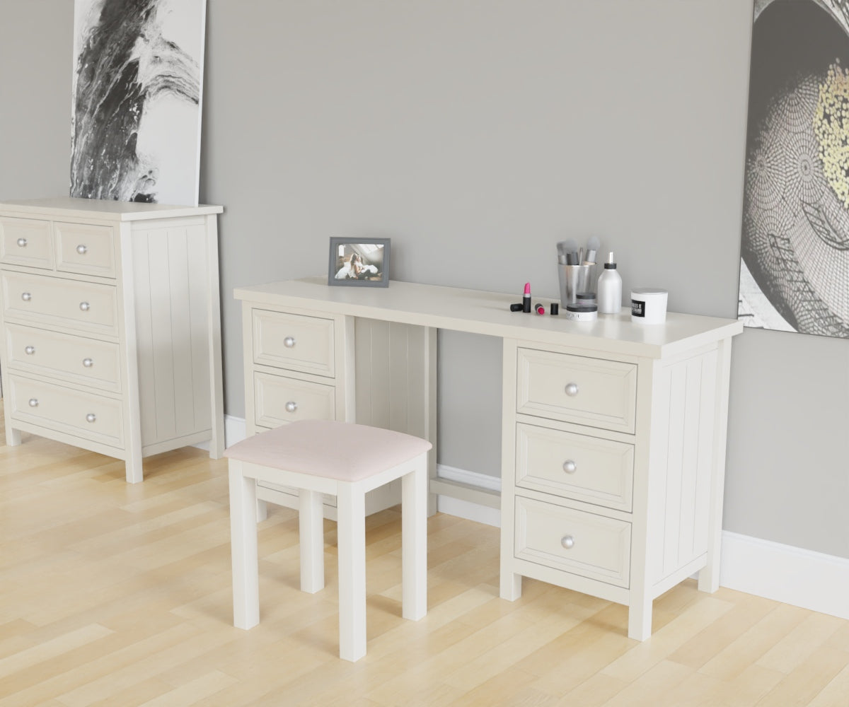 Maine Dressing Table in white has a square-edged top, with 3 vertical drawer at both ends. This lifestyle image features other products from the Julian Bowen Maine range.